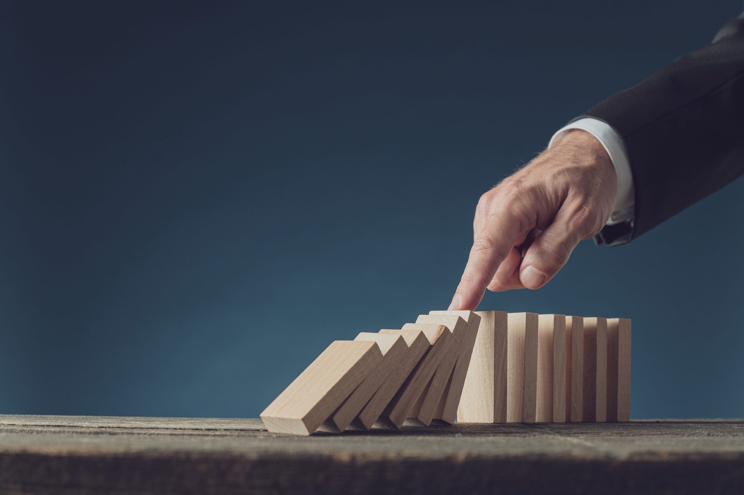 cropped-business-crisis-manager-stopping-collapsing-domino-2021-08-30-00-59-21-utc-scaled-1.jpg